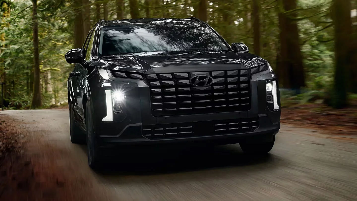 2024 Hyundai Palisade Calligraphy Night Edition driving down a road