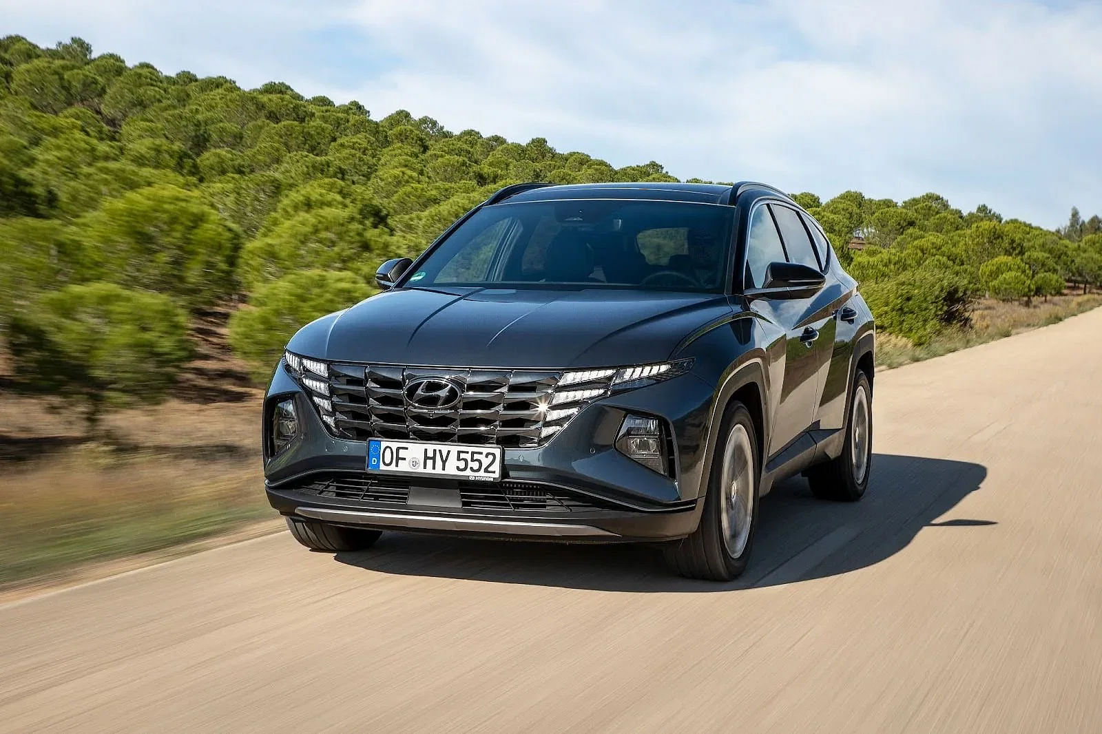 2024 Hyundai Tucson driving down a road